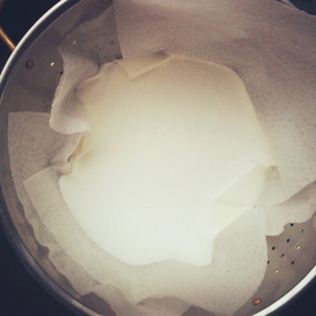 Home-made yoghurt being strained